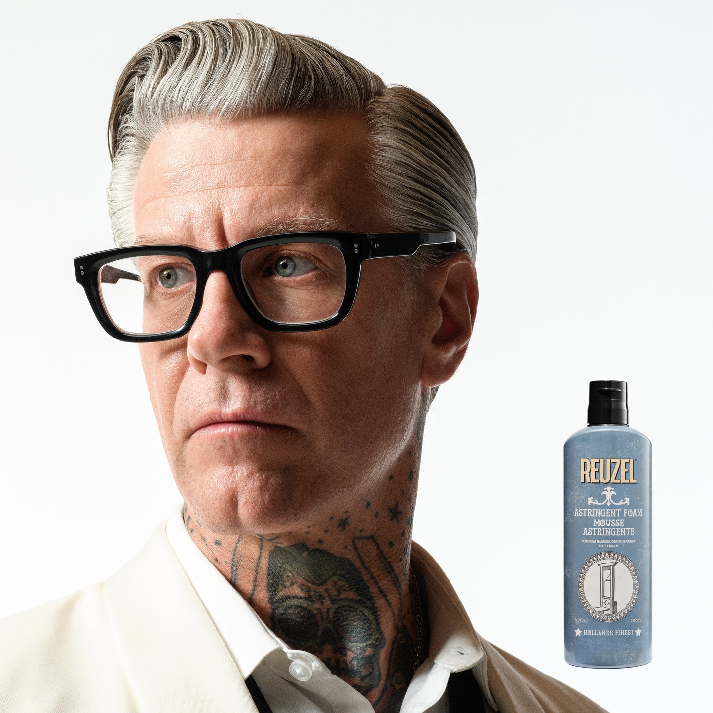Reuzel Astringent Foam for beard care, showing a pump bottle and foam texture in a close-up shot.