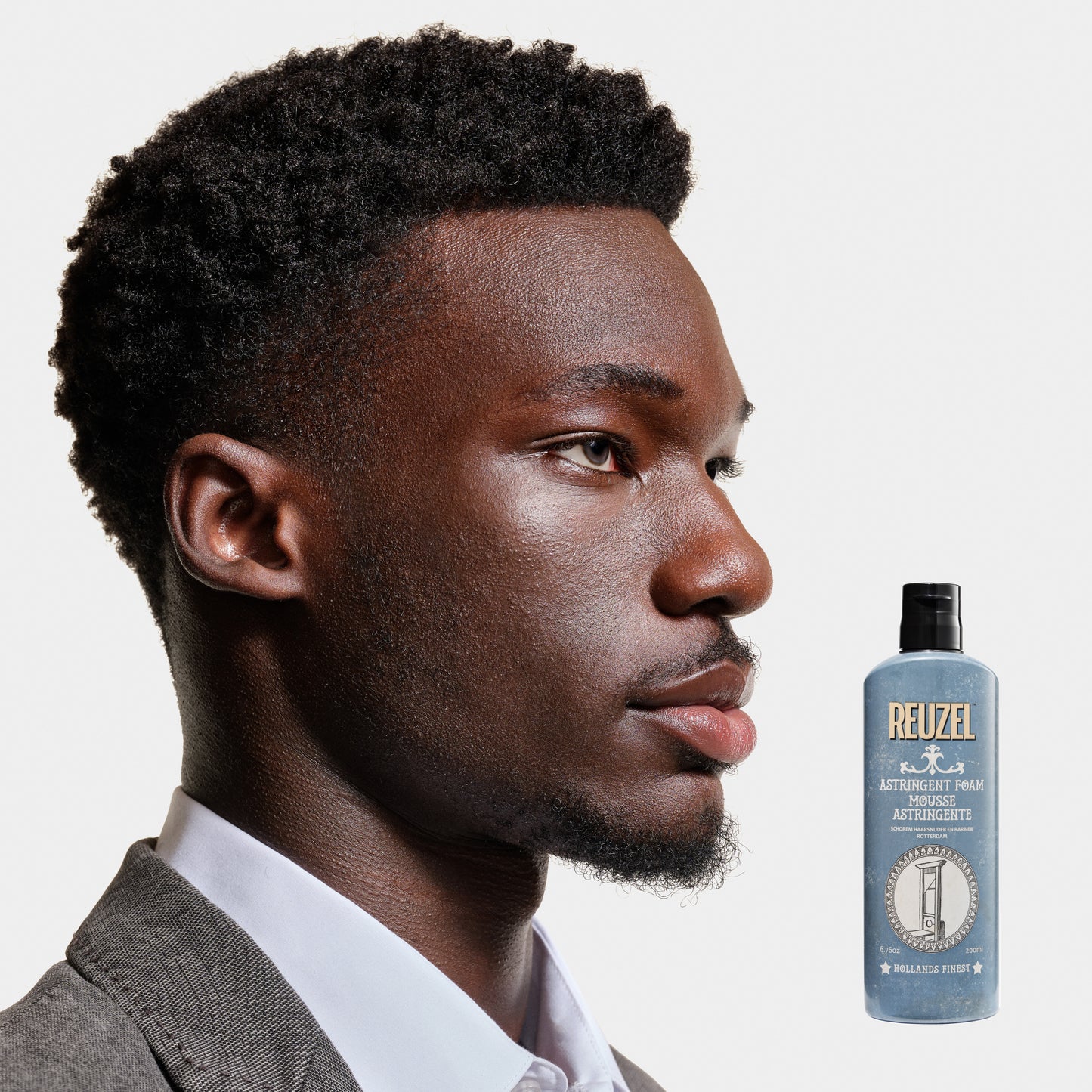 Reuzel Astringent Foam beard grooming product in a white tube with black cap, designed for refreshing and tightening beard skin.