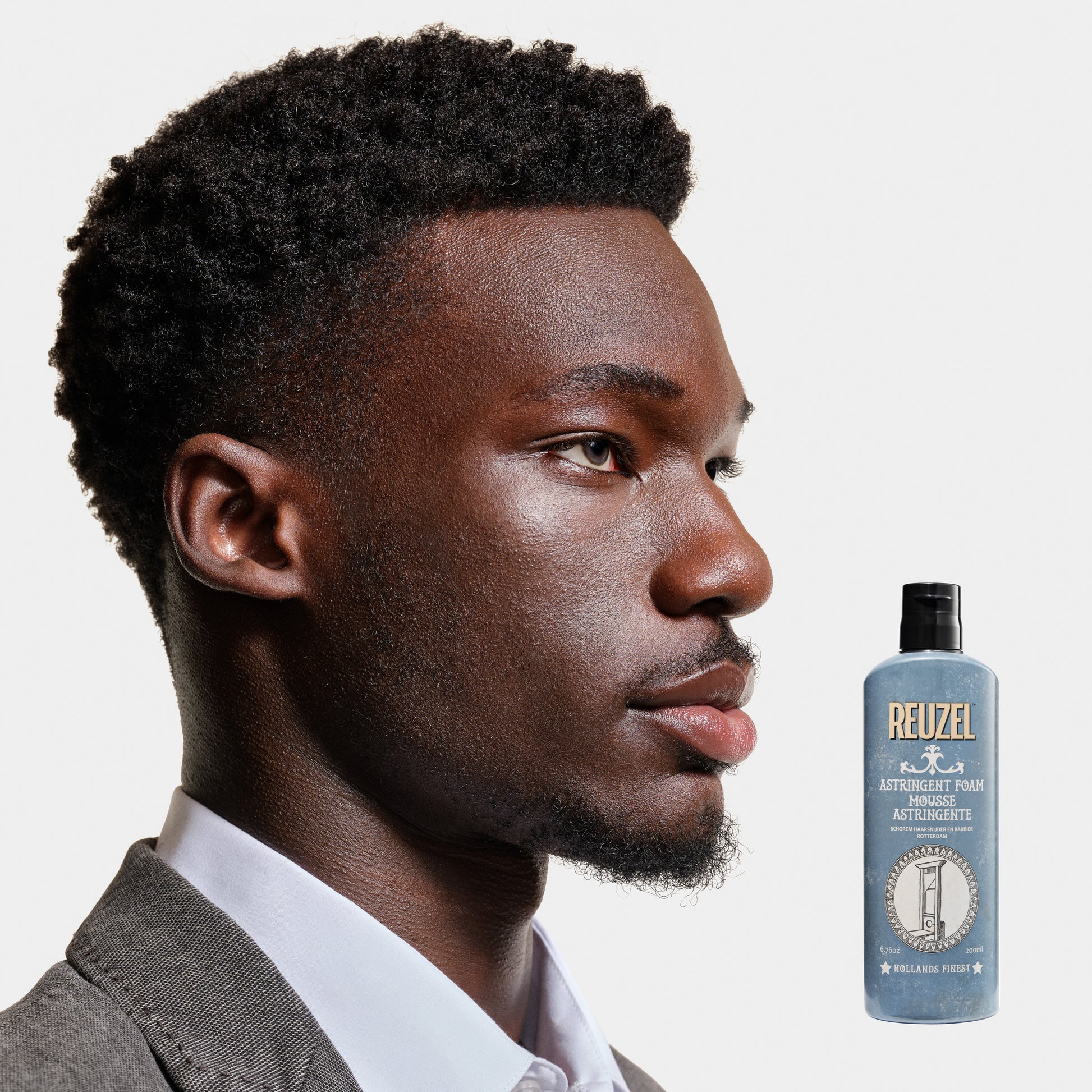 Reuzel Astringent Foam beard grooming product in a white tube with black cap, designed for refreshing and tightening beard skin.
