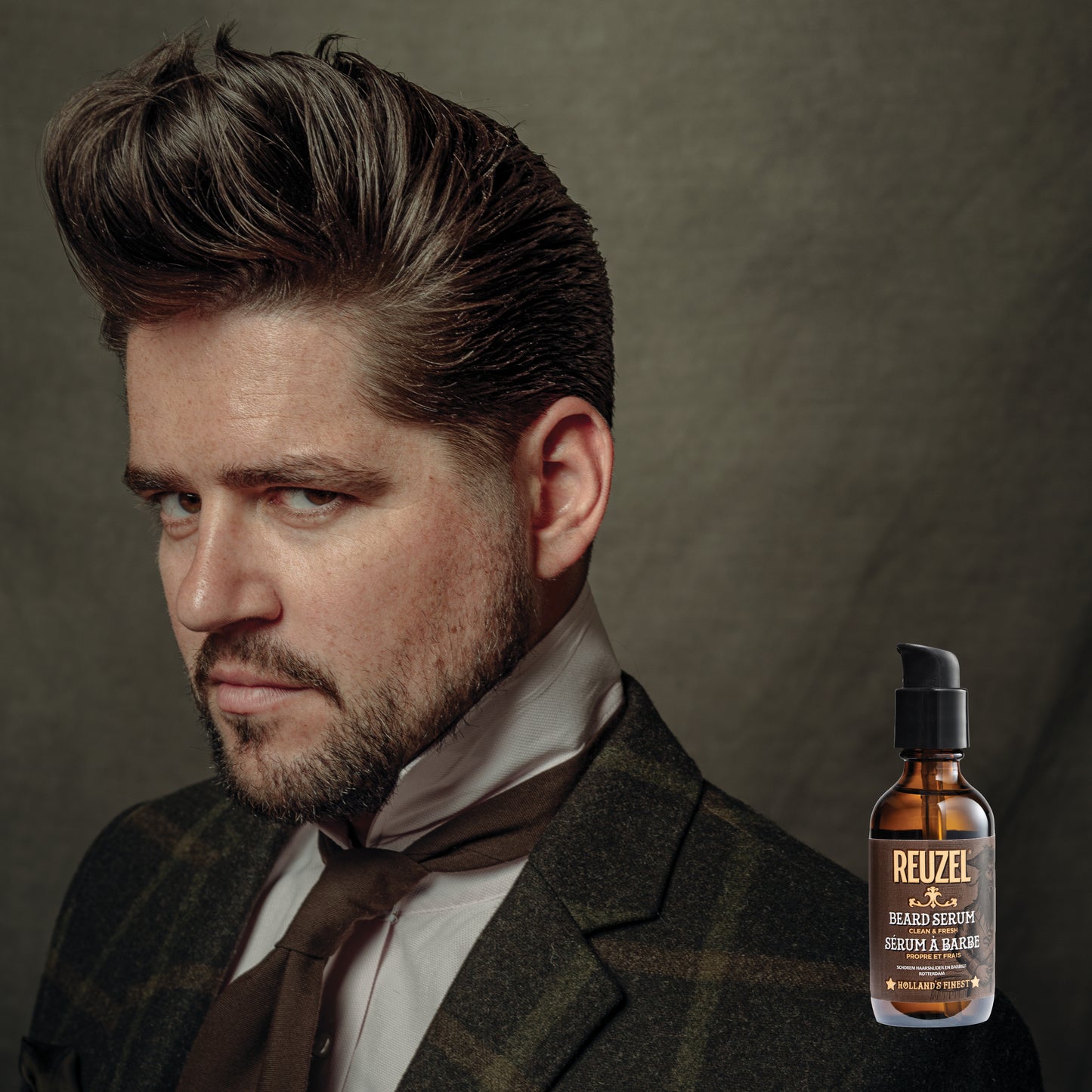 Reuzel beard oil in a clear bottle showing the clean and fresh beard serum, designed to nourish and soften facial hair.