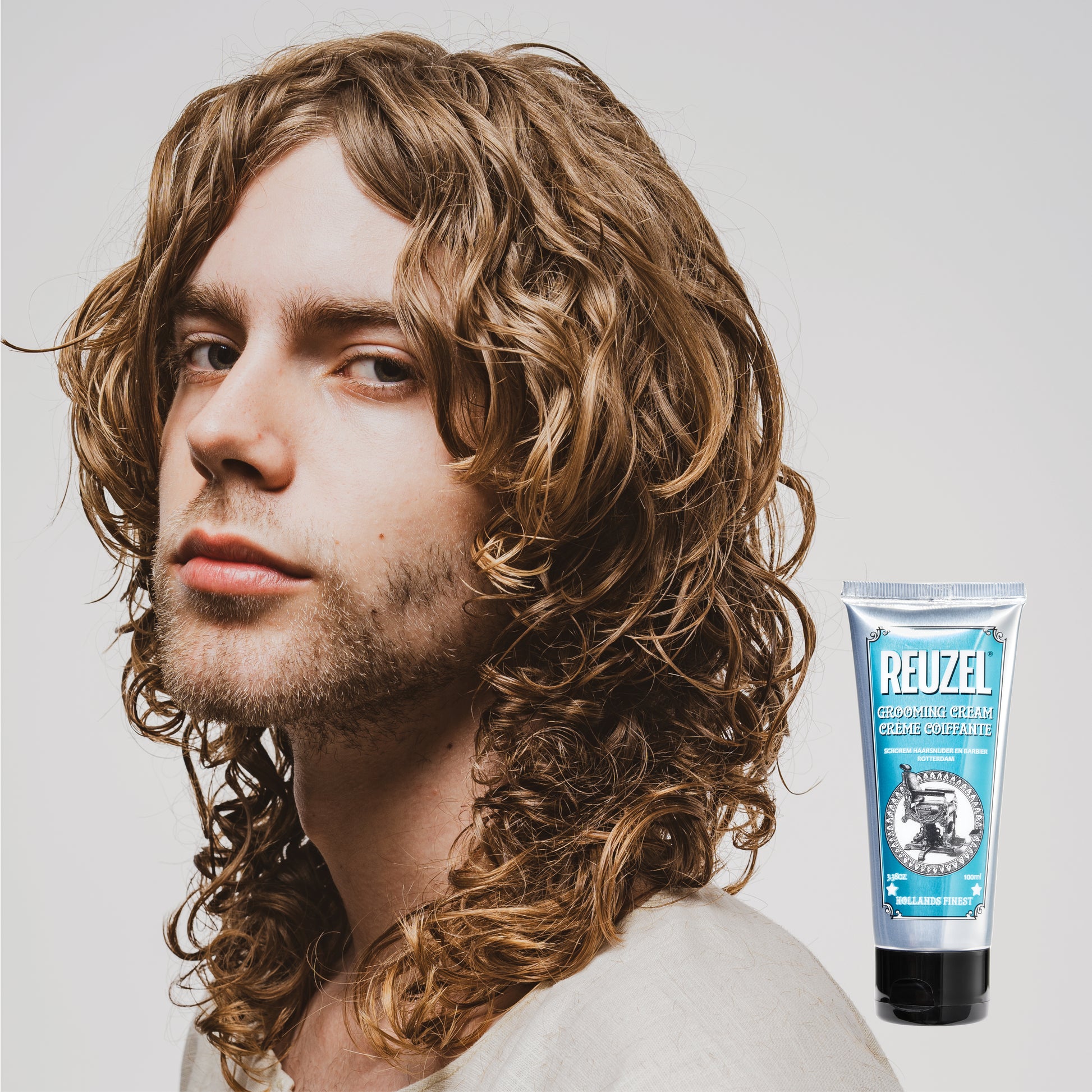 Reuzel Grooming Cream for hair styling, featuring a creamy texture and styling hold, suitable for smooth, textured hairstyles.