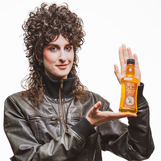 Reuzel grooming tonic in a clear bottle, showing hair tonic liquid with a modern label, used for styling and hair care.