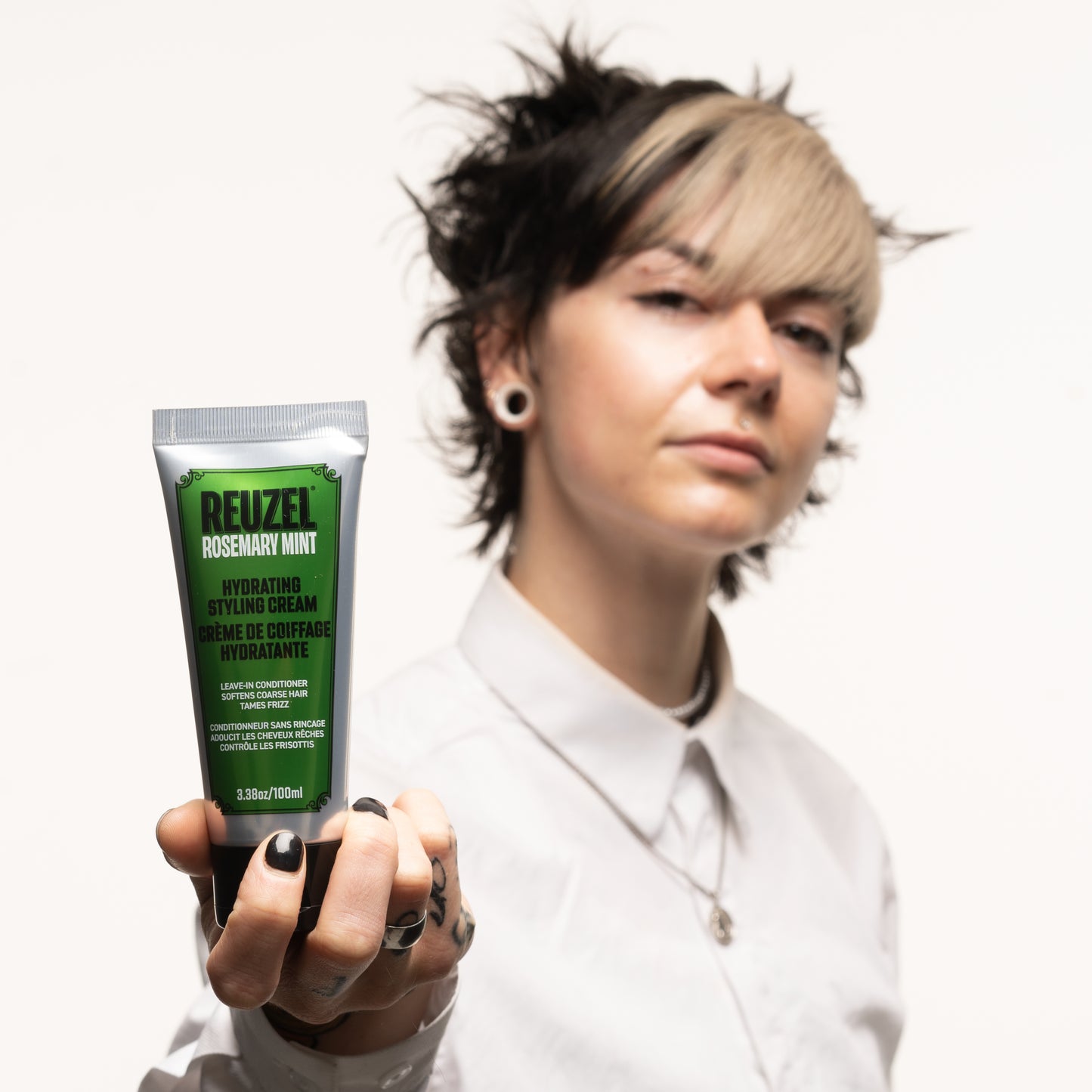 Reuzel Hydrating Styling Cream for hair, showing a jar of the hair styling product with a smooth, creamy texture.