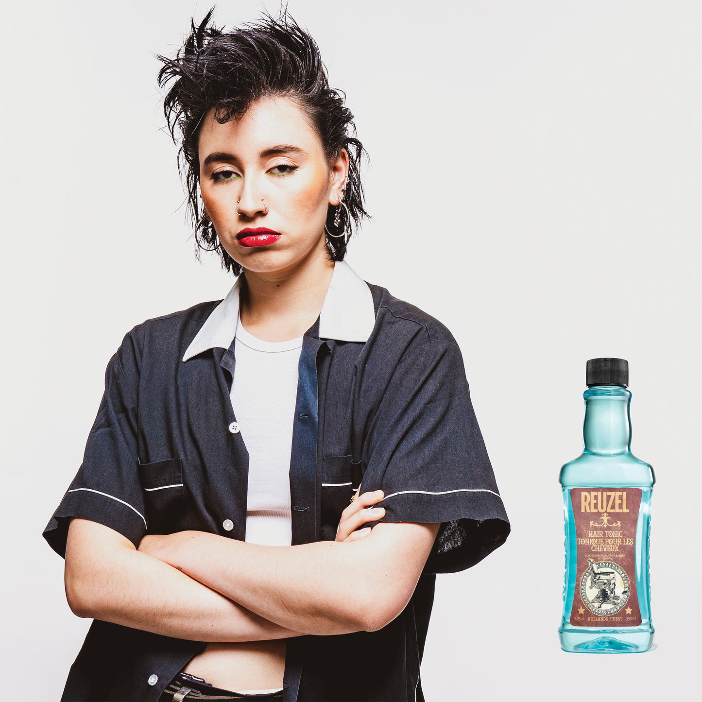 Reuzel Hair Tonic bottle with label, showcasing the hair styling product in a clear, professional shot.