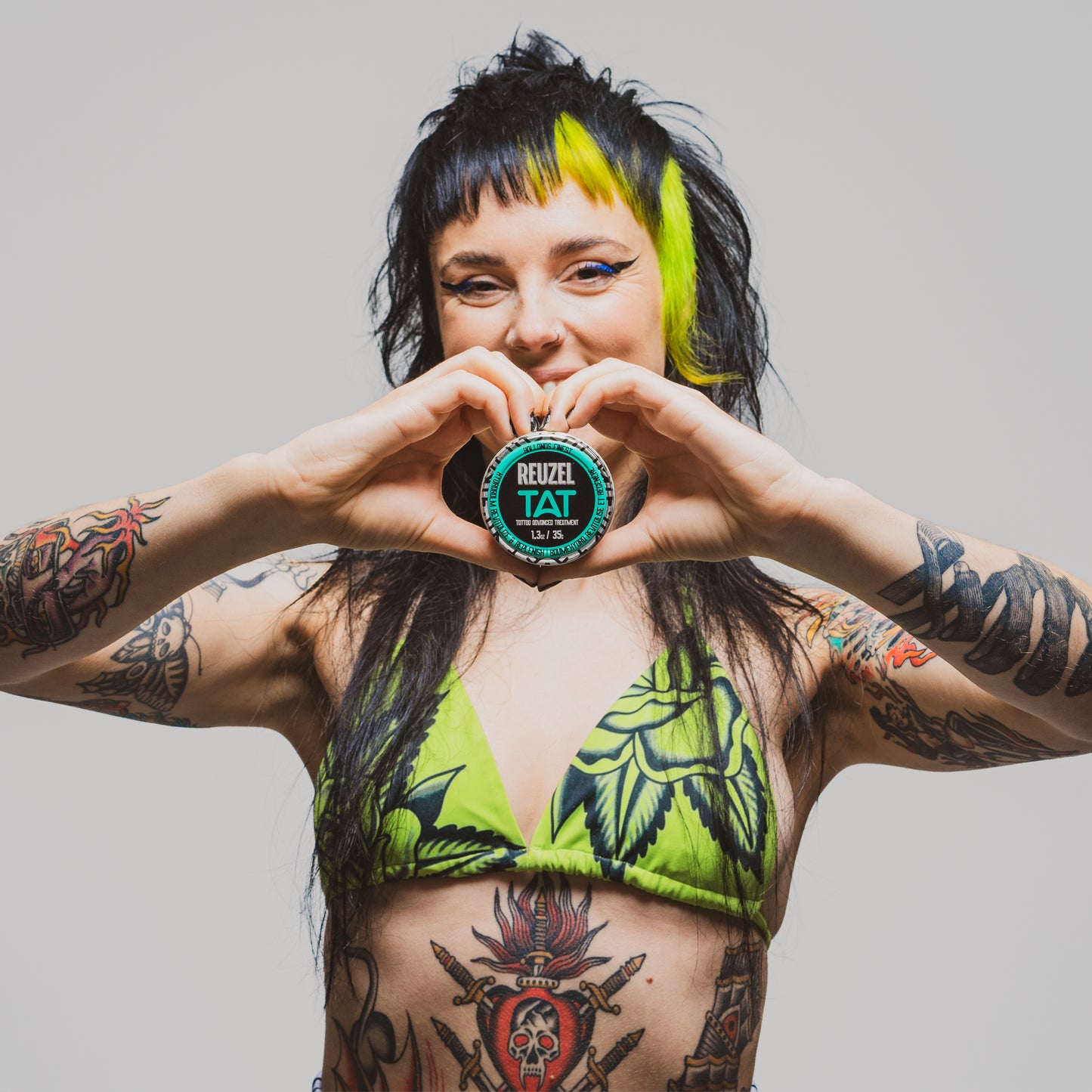 Reuzel TAT Hydrabalm tattoo aftercare balm in a small jar, designed for moisturizing and healing fresh tattoos.