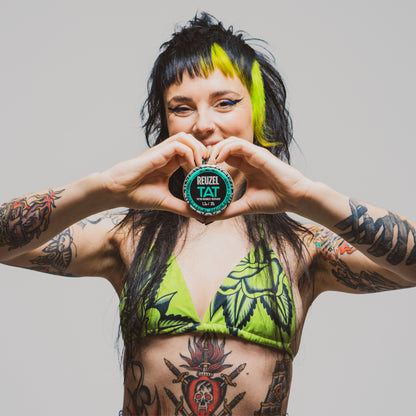 Reuzel TAT Hydrabalm tattoo aftercare balm in a small jar, designed for moisturizing and healing fresh tattoos.