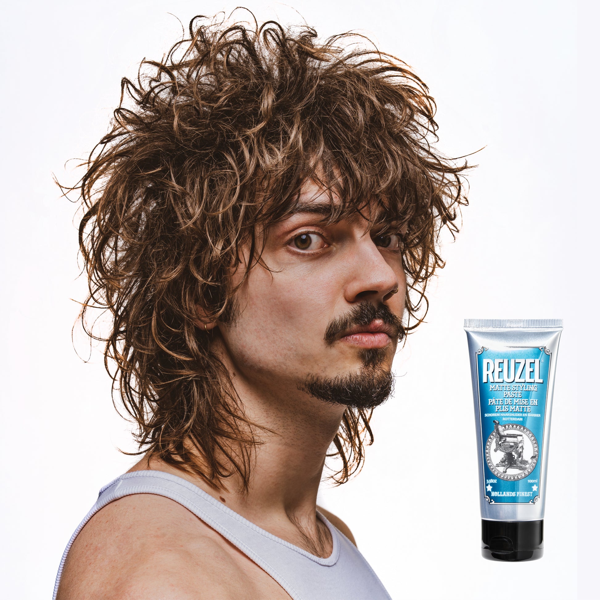 Reuzel Matte Styling Paste in a squeeze tube, showcasing its smooth, matte finish for versatile hair styling.