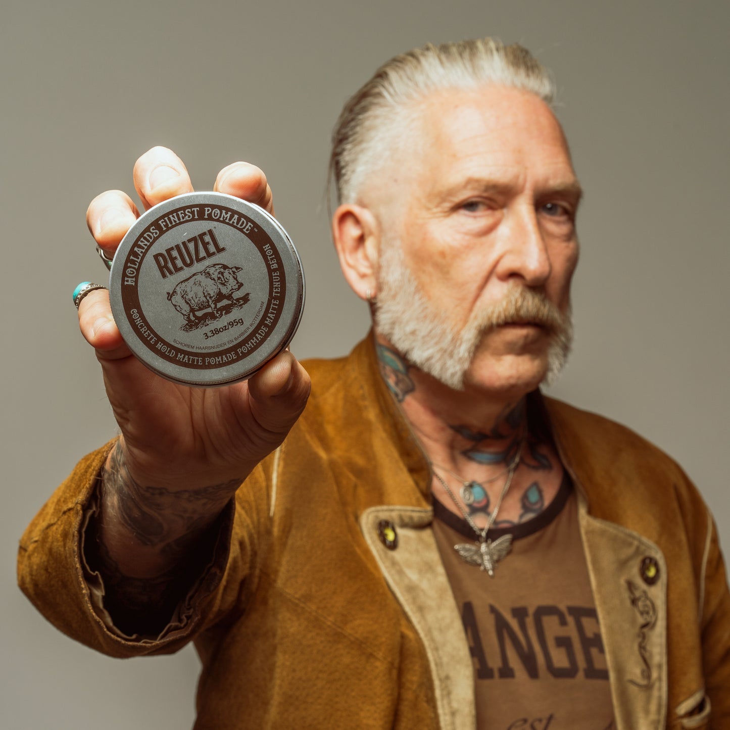 Reuzel Concrete Hold Matte Pomade jar with black and gray packaging, showcasing the product label and lid.