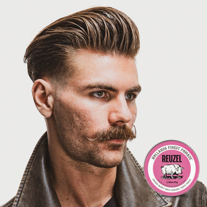 Pink Reuzel Pomade grease jar showing the smooth, glossy pink pomade inside with the brand label visible.