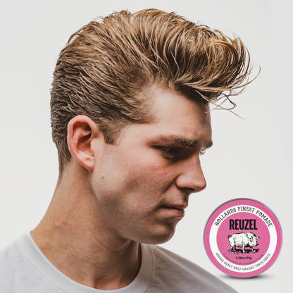 Reuzel Pink Pomade Grease in a jar, showcasing its vibrant pink color and classic pomade texture for styling hair.