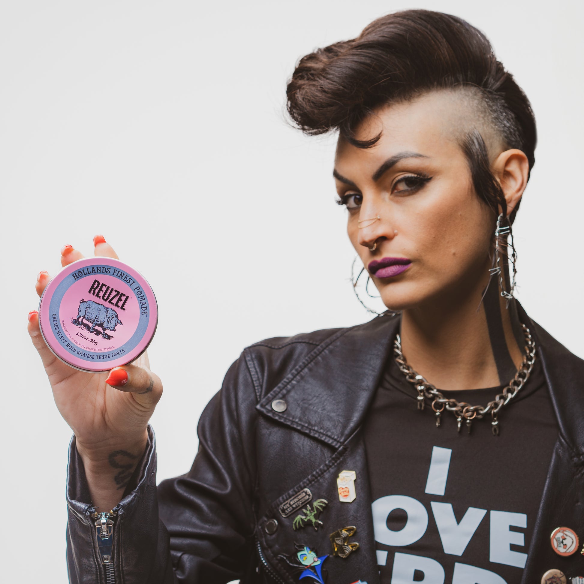 Pink Reuzel Pomade grease in a jar, showing the smooth, glossy pink pomade texture ideal for styling hair.