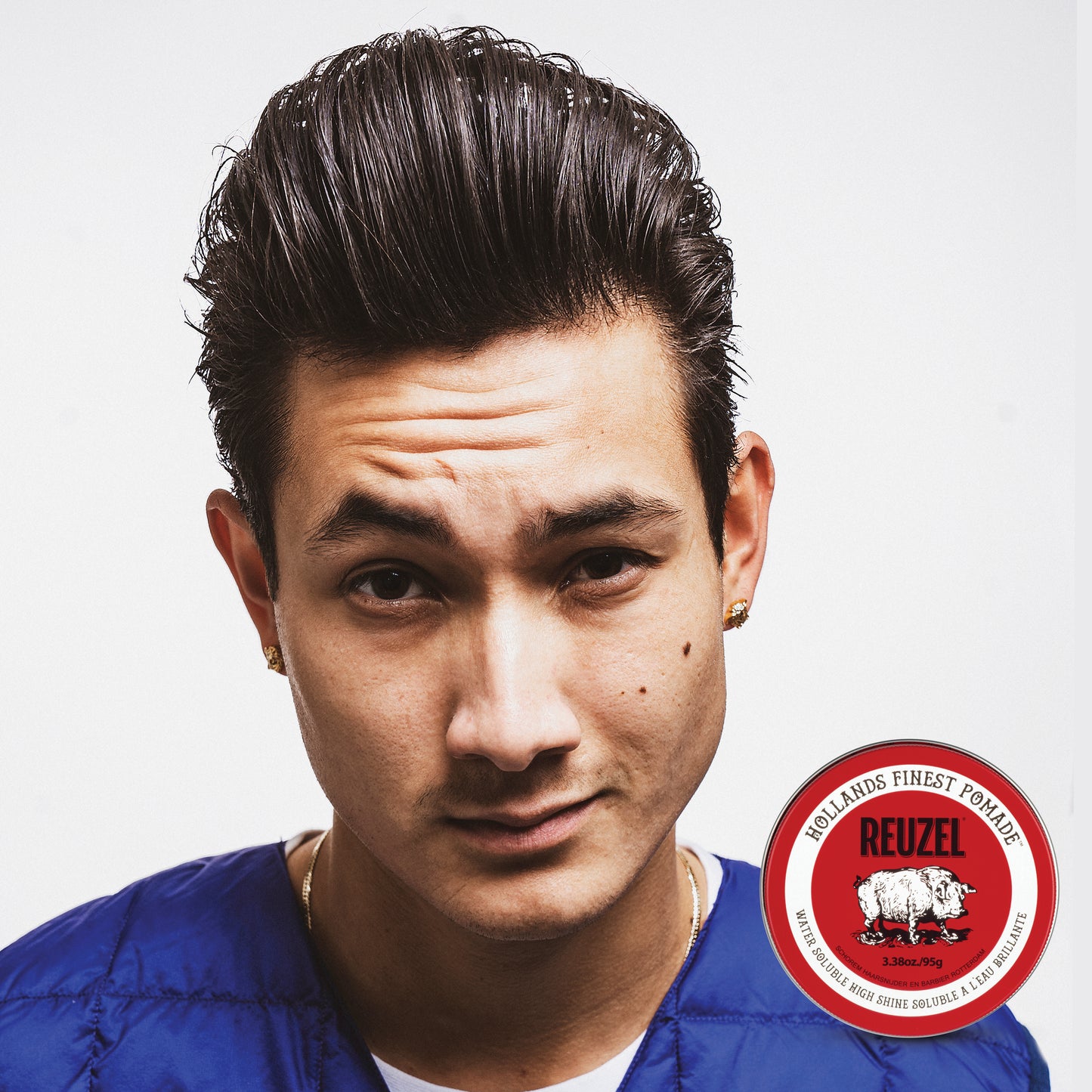 Reuzel Road Trip To Go Red Pomade in a metal tin, showcasing vibrant red pomade for styling hair.