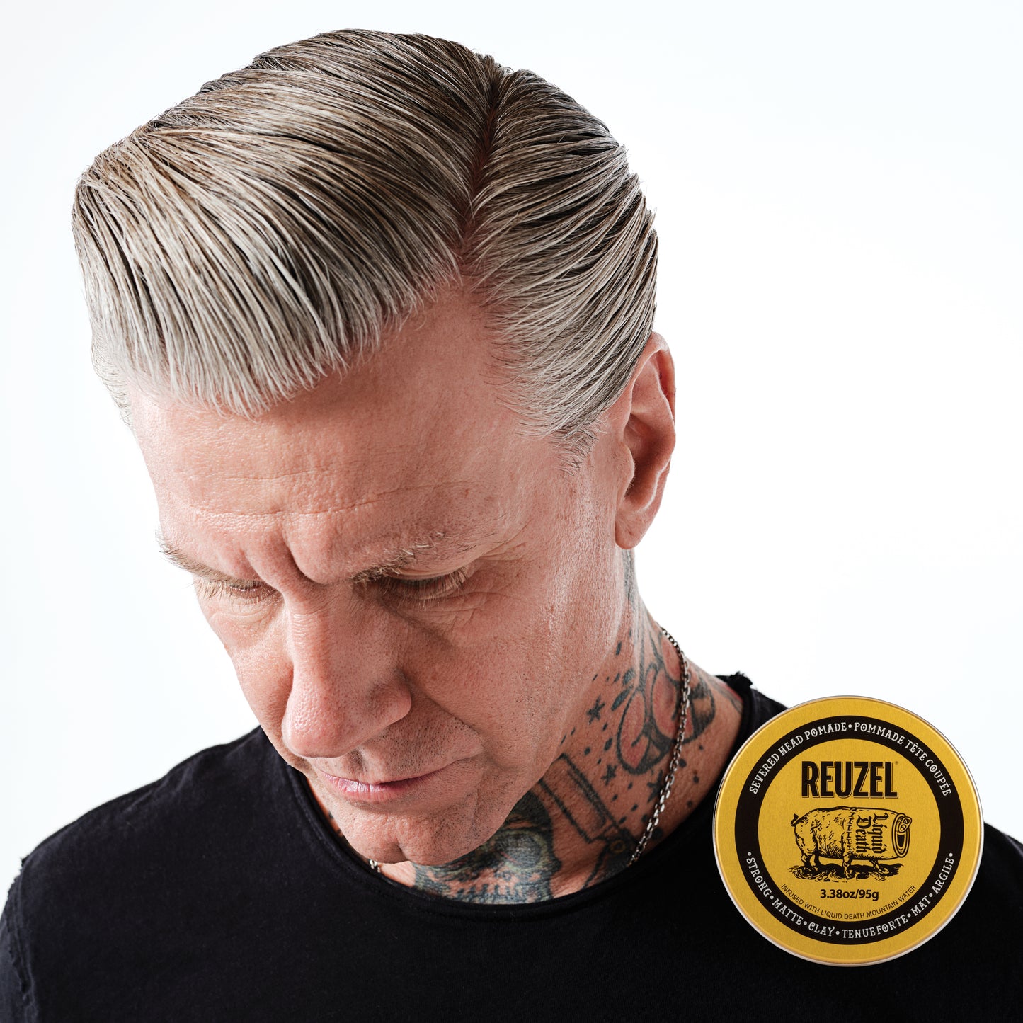 Reuzel x Liquid Death Severed Head Pomade jar with black lid and label, featuring bold graphic design and product branding.