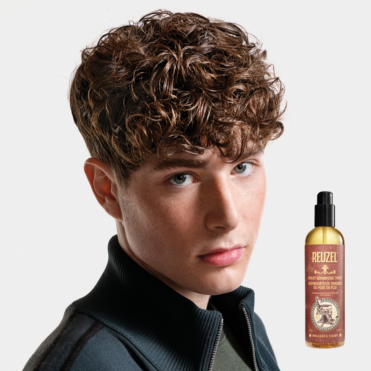Reuzel Spray Grooming Tonic hair tonic in a spray bottle, designed for styling and refreshing hair.