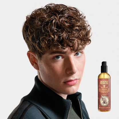 Reuzel Spray Grooming Tonic hair tonic in a spray bottle, designed for styling and refreshing hair.