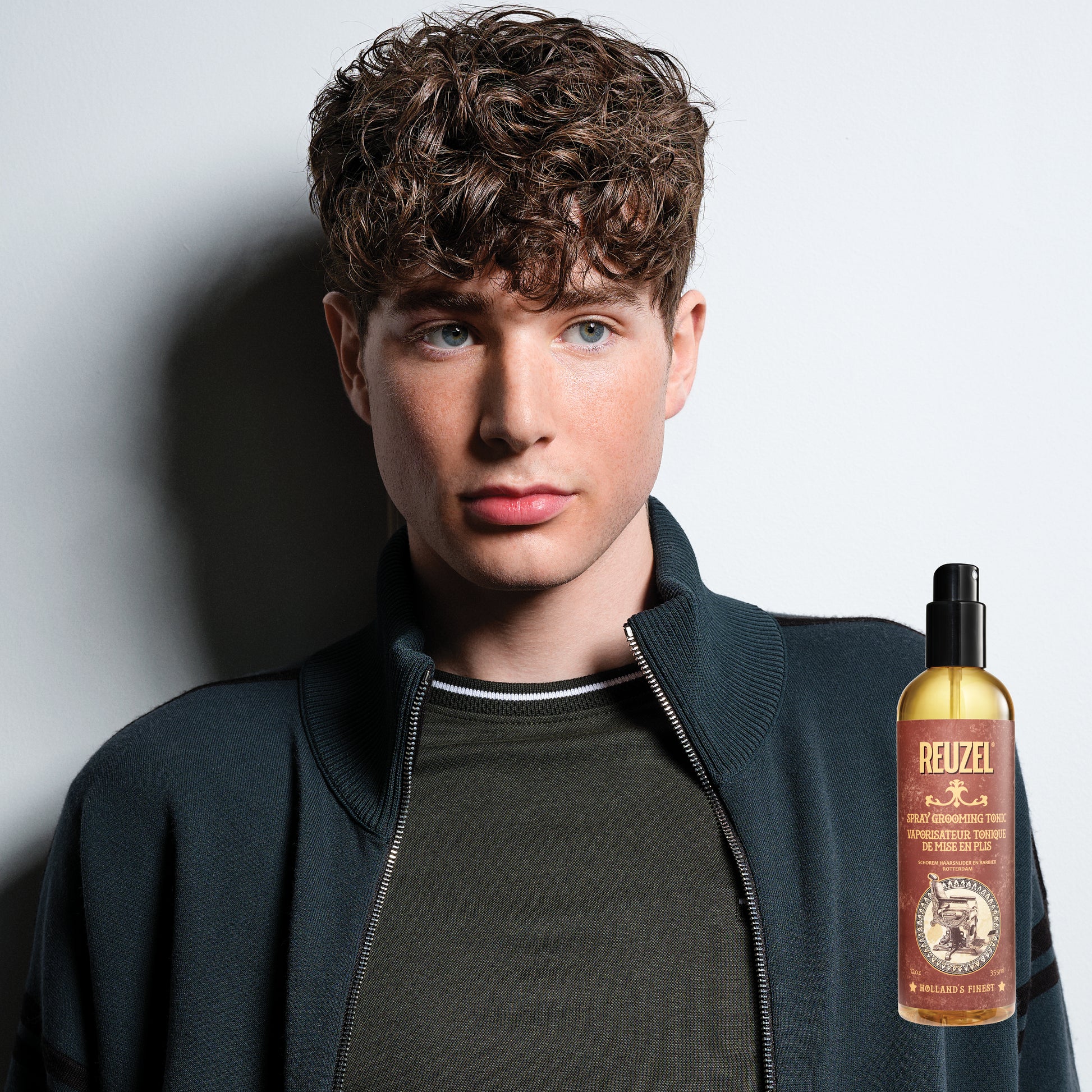Reuzel Spray Grooming Tonic hair tonic in a spray bottle, designed to refresh and style hair.