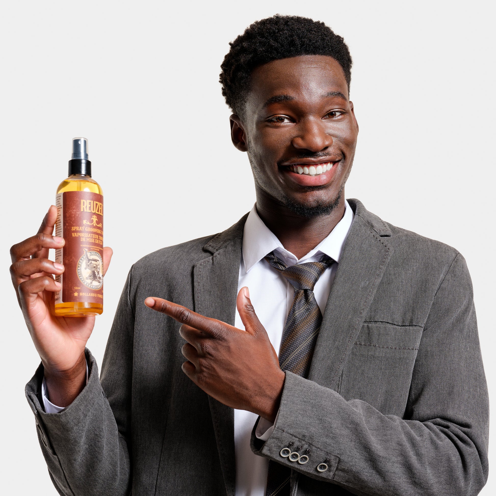 Reuzel Spray Grooming Tonic in a spray bottle, designed for hair styling and grooming.