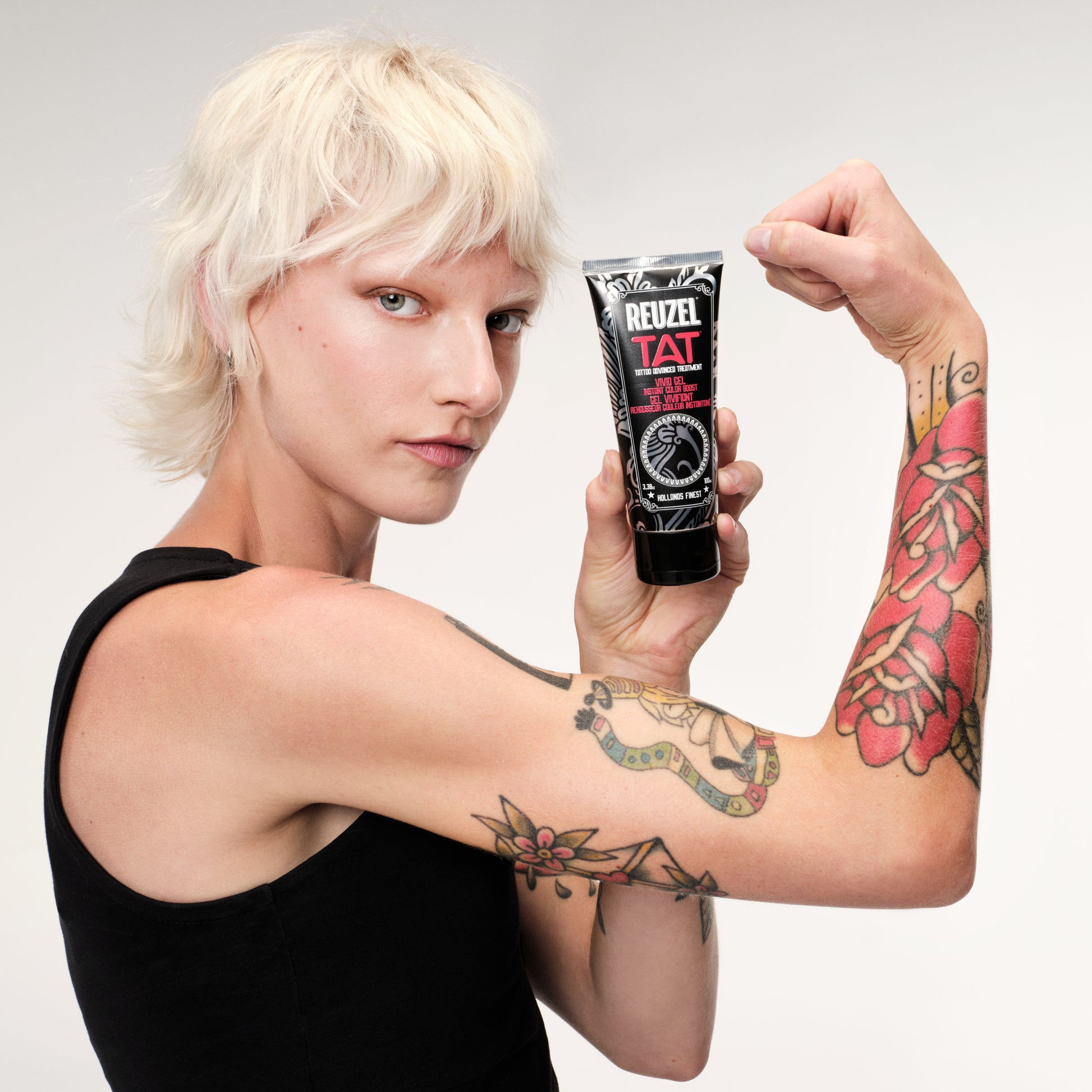 Reuzel TAT Vivid Gel tattoo aftercare product in a clear jar with a white lid and vibrant label, ready for application.