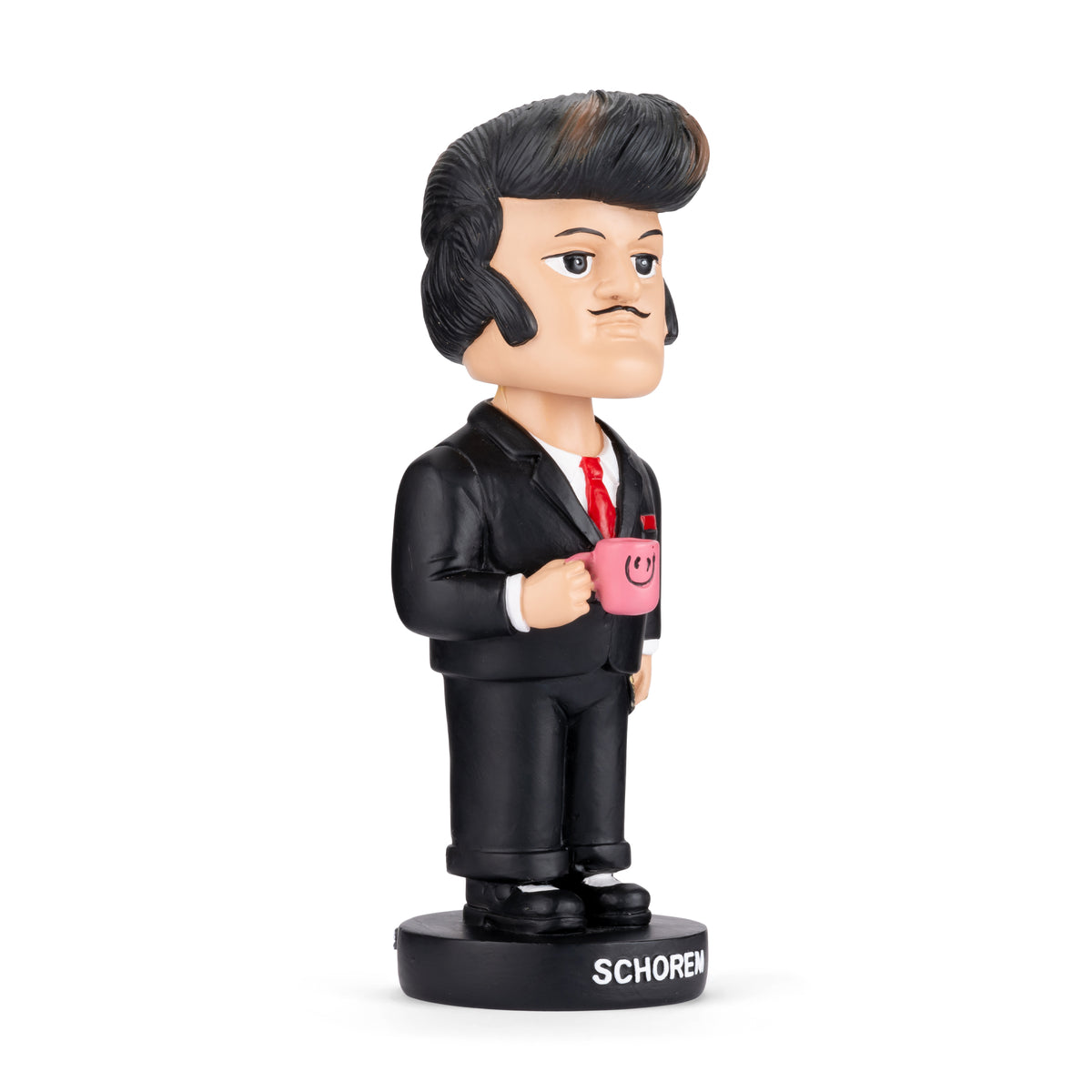 A collectible bobblehead figurine of a man in a black suit holding a pink mug, standing on a black base labeled 'SCHOREN' in white text, photographed against a solid white background.