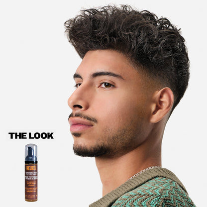 Reuzel Grooming Tonic Texture Foam for hair styling, showing the foam in a clear container with a smooth, airy texture.