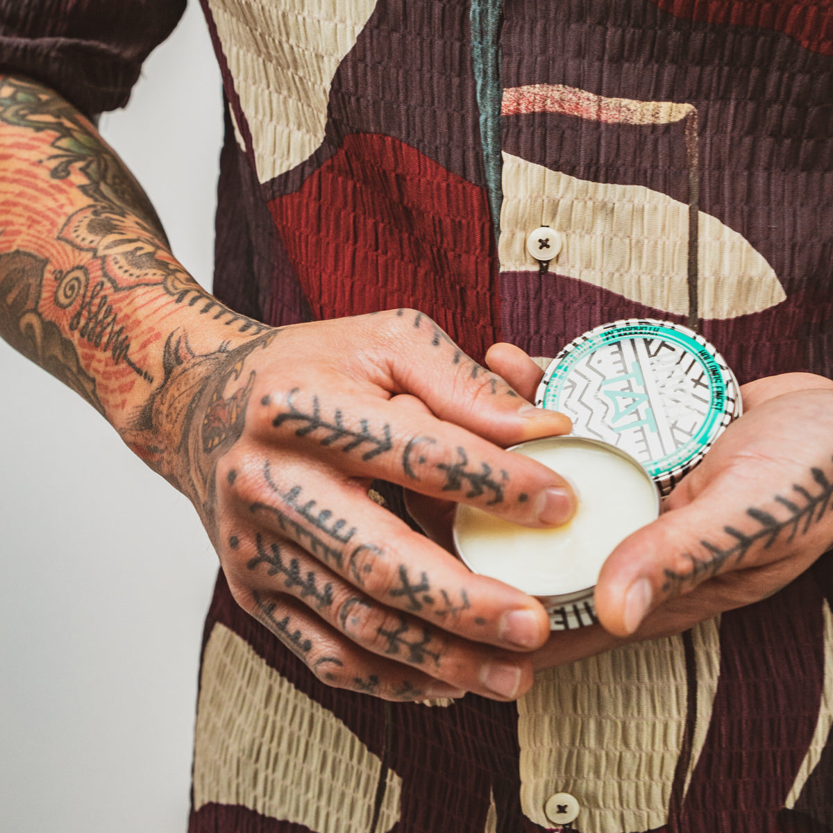 Reuzel TAT Hydrabalm tattoo aftercare product in a sleek tube, designed to moisturize and protect fresh tattoos.